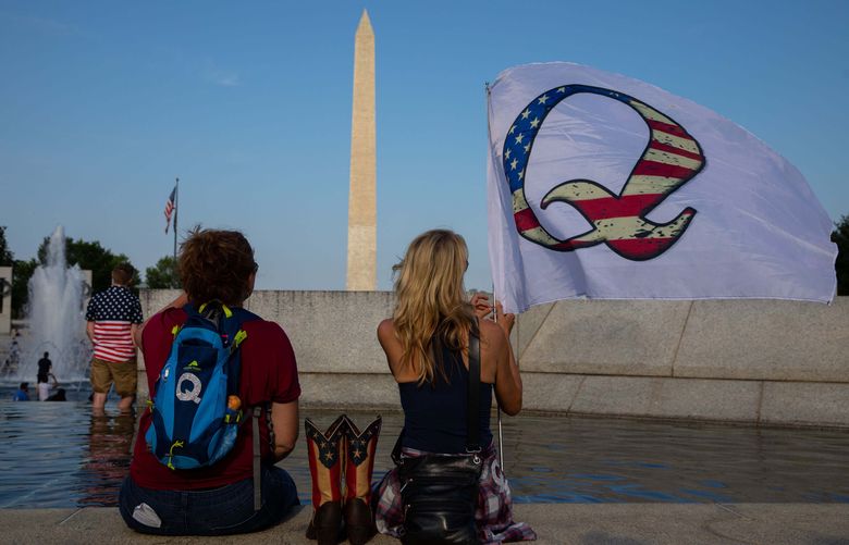 Qanon supporters wait for the military flyover at the World War II Memorial during July 4th celebrations in Washington, D.C., in 2020. MUST CREDIT: Photo for The Washington Post by Evelyn Hockstein