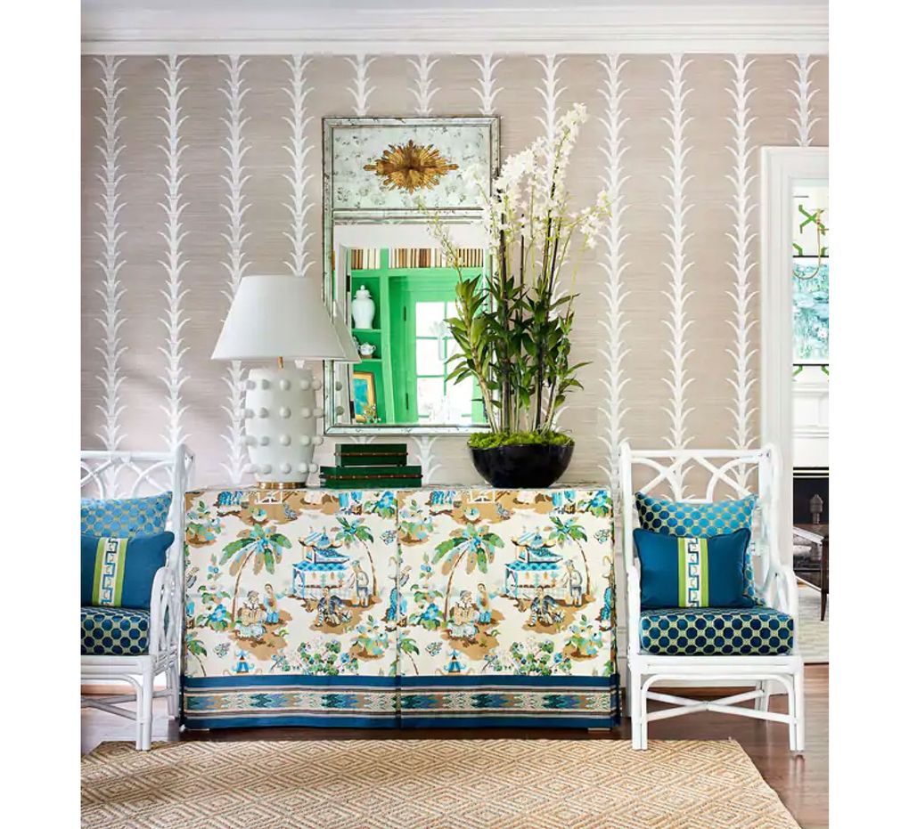 For designer Edith-Anne Duncan, the starting point for this space was Brunschwig & Fils’s Xian fabric on the skirted table. She added a contrasting linear tape at the bottom of the skirt against the free-flowing pattern. On the walls, she used a classic grass cloth with linear designs. Velvet gros point on the chairs is paired with pillows adorned with a Greek key design. (Dustin Peck)