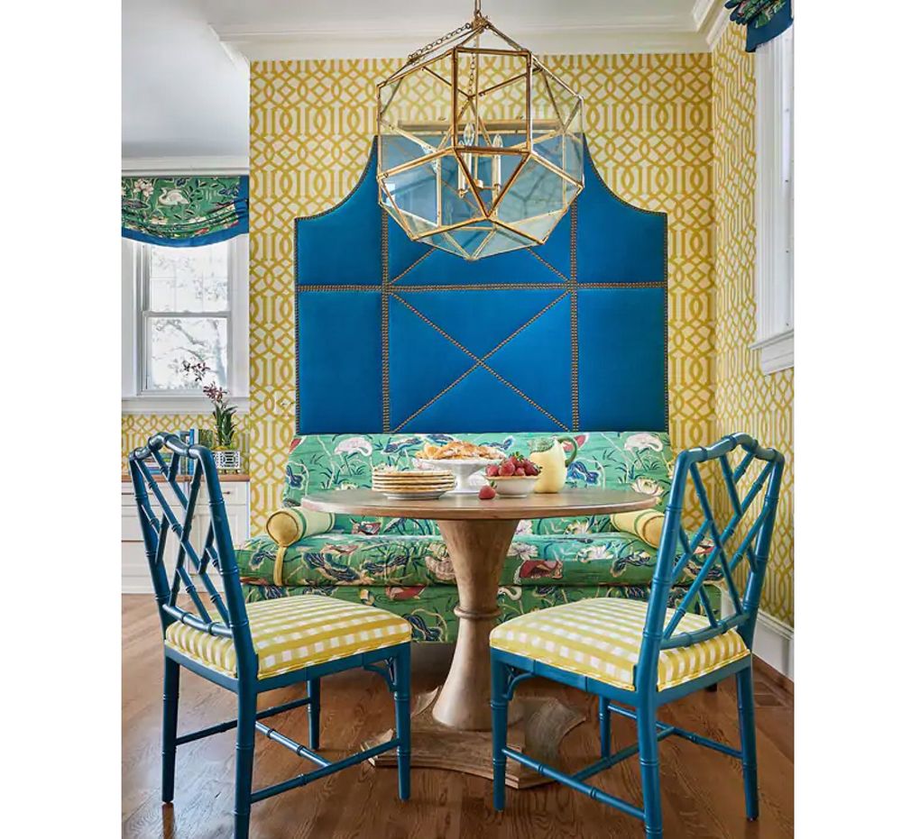 Designer Edith-Anne Duncan paired the busy statement floral on the banquette with a classic geometric wallpaper and Schumacher’s Bermuda Check on the chairs. Solid velvet upholstery behind the banquette adds an element of texture. (Dustin Peck)