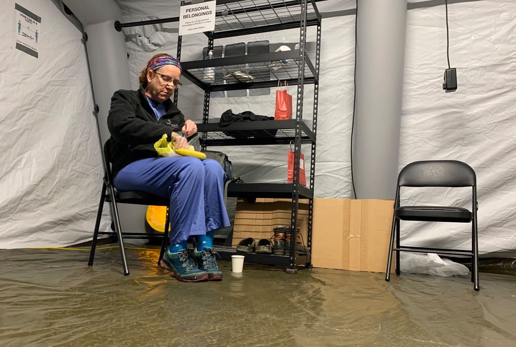 Chris Rutledge, a nurse for Samaritan’s Purse, eats lunch, Friday, Jan. 15, 2021, during the only short break of her 12-hour shift inside the COVID-19 field hospital built by the Christian relief organization, in Lenoir, N.C. Caldwell Memorial Hospital asked for help from Samaritan’s Purse as cases in the North Carolina foothills skyrocketed and bed space dwindled. (AP Photo/Sarah Blake Morgan)