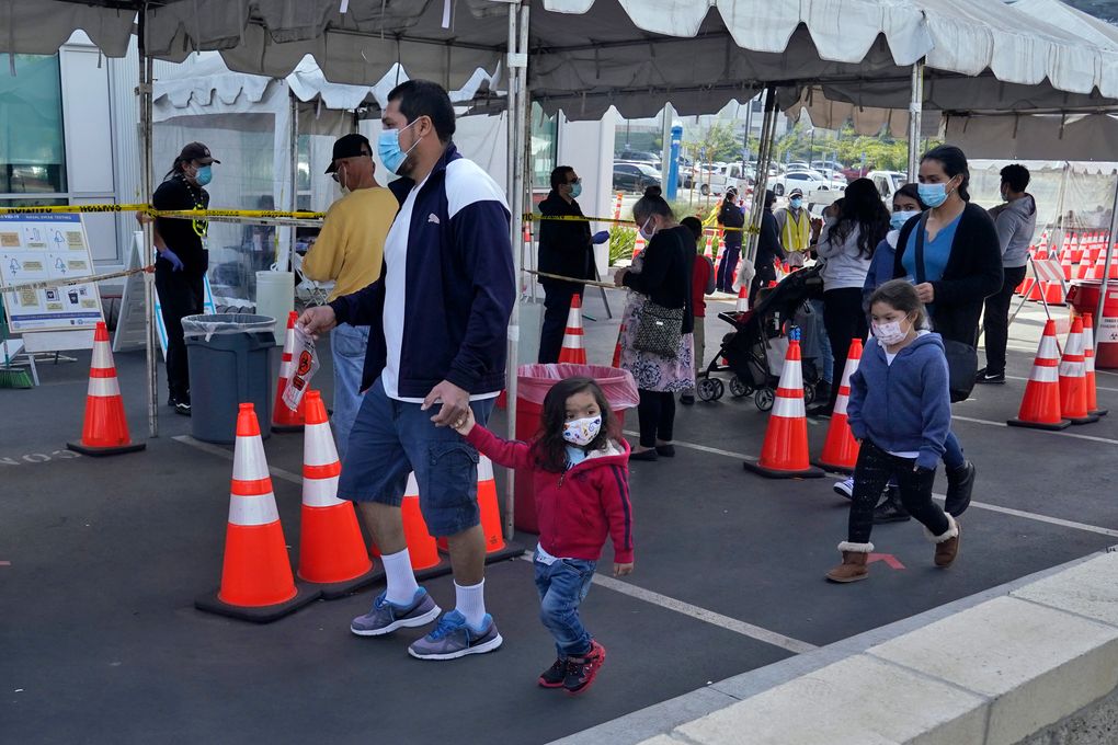 FILE – In this Jan. 7, 2021, file photo, people walk to a tent at a COVID-19 walk-up testing site on the Martin Luther King Jr. Medical Campus in Los Angeles, Jan. 7, 2021. Coronavirus deaths and cases per day in the U.S. dropped markedly over the past couple of weeks but are still running at alarmingly high levels, and the effort to snuff out COVID-19 is becoming an ever more urgent race between the vaccine and the mutating virus. (AP Photo/Marcio Jose Sanchez, File)