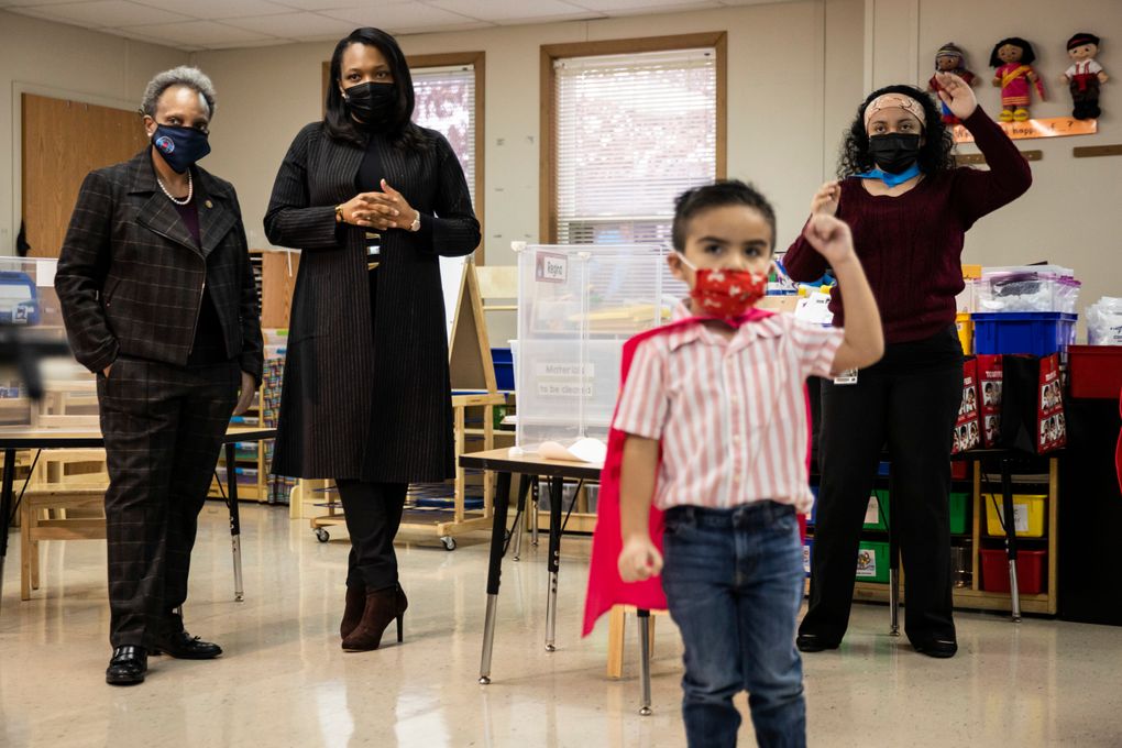 Mayor Lori Lightfoot, left, and Chicago Public Schools CEO Janice Jackson, second from left, visit a preschool classroom at Dawes Elementary School in Chicago, Monday, Jan. 11, 2021. It was the first day of optional in-person learning for preschoolers and some special education students in Chicago Public Schools after going remote last March due to the coronavirus pandemic. President Biden is pushing for schools to reopen. (Ashlee Rezin Garcia/Chicago Sun-Times via AP, Pool)