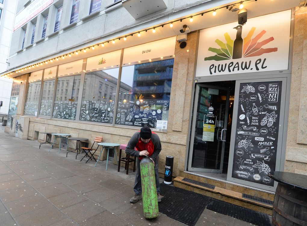 A man delivers a supply of heating gas to Warsaw’s popular Piw Paw pub in Warsaw, Poland, Monday, Jan. 25, 2021, a business that is struggling to survive under lockdown by organizing legal, small-scale educative meetings and courses for beer lovers. (AP Photo/Czarek Sokolowski)