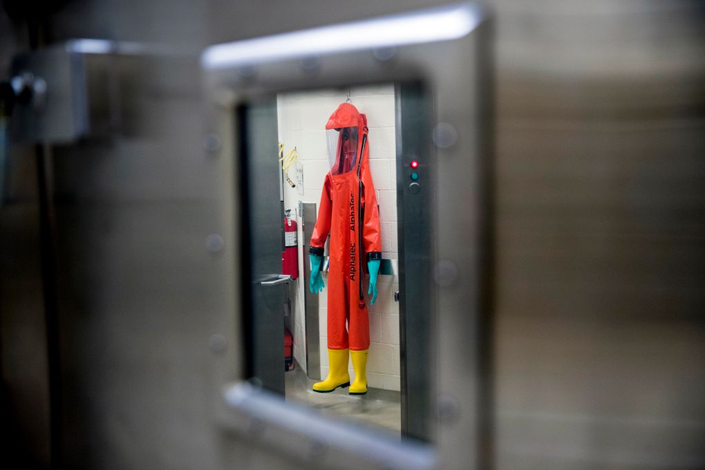FILE – In this March 19, 2020, file photo, a biosafety protective suit for handling viral diseases are hung up in a biosafety level 4 training facility at U.S. Army Medical Research and Development Command at Fort Detrick in Frederick, Md., where scientists are working to help develop solutions to prevent, detect and treat the coronavirus. China is trying to spread doubt about the effectiveness of Western vaccines and the origin of the coronavirus as a World Health Organization-selected team of scientists are in the city where the pandemic first broke out. (AP Photo/Andrew Harnik, File)
