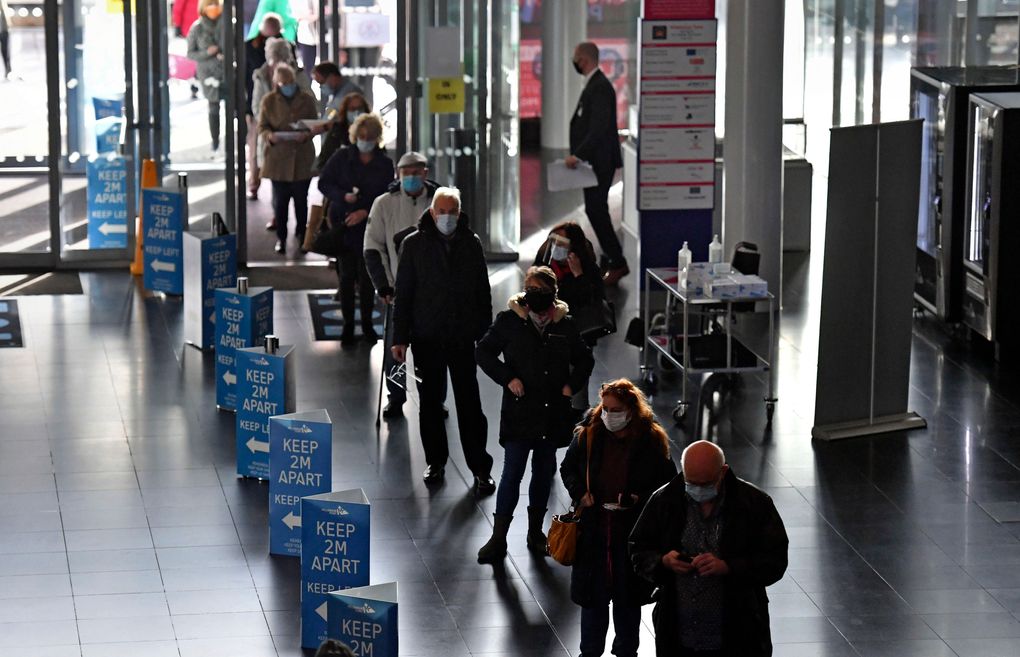 People wait to receive a Covid-19 vaccine at the NHS vaccine centre that has been set up at Millennium Point centre in Birmingham, England, Monday Jan. 11, 2021. The centre is one of the seven mass vaccination centres now opened to the general public as the government continues to ramp up the vaccination programme against Covid-19. (Jacob King / The Associated Press)