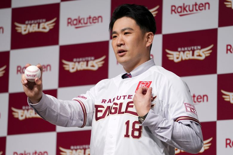 Japanese baseball pitcher Masahiro Tanaka wearing his jersey poses