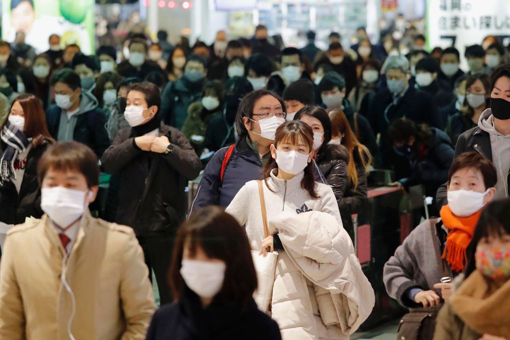 Commuters wear face masks at a station in Fukuoka, southern Japan Thursday, Jan. 14, 2021. Japan expanded a coronavirus state of emergency to seven more prefectures, affecting more than half the population amid a surge in infections across the country. (Naoyuki Shin / Kyodo News via AP)
