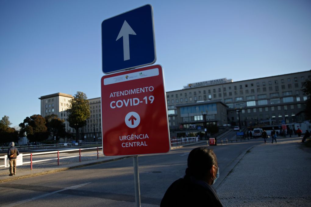 FILE – In this Jan. 18, 2021, file photo, a sign shows the way to the COVID-19 emergency ward at the Santa Maria hospital in Lisbon. (AP Photo/Armando Franca)