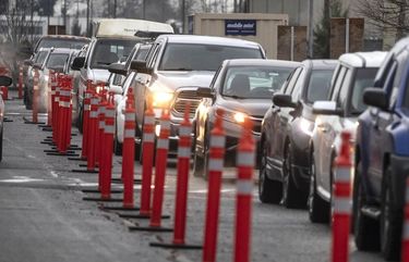 Monday, Feb. 1, 2021 Cars liining up at the GSA Complex in Auburn, one of two Mass vaccination sites opening today in South King County. 216262