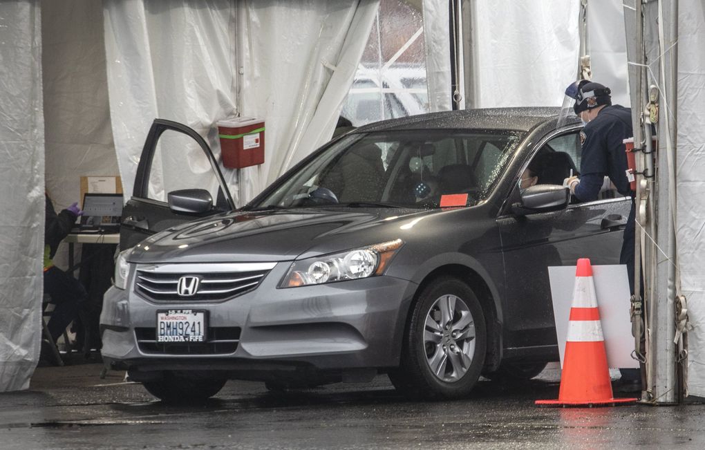 Drivers pulled into vaccine bays like this one at the new mass vaccine site at the GSA Complex in Auburn on Monday. (Steve Ringman / The Seattle Times)