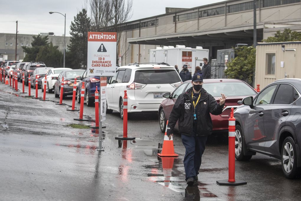 Cars line up at the GSA Complex in Auburn on Monday, one of two mass vaccination sites open on Monday in South King County. Demand for the vaccine is so great that all appointments at the current Auburn and Kent mass vaccination sites have been filled through February. (Steve Ringman / The Seattle Times)