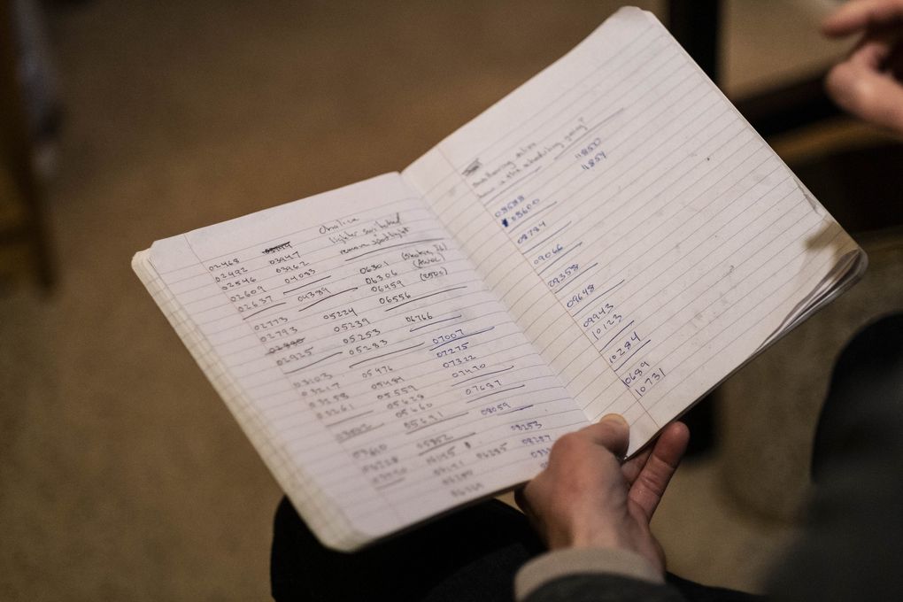 David Goss-Grubbs keeps track of his progress on recording his own voice with a notebook that accounts for thousands of phrases. (Dean Rutz / The Seattle Times)