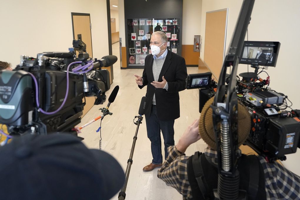 Washington Gov. Jay Inslee talks to reporters, Tuesday during a visit to Elk Ridge Elementary School in Buckley, Wash. Inslee said Thursday that the state has given 770,000 COVID-19 vaccinations. (Ted S. Warren / The Associated Press)