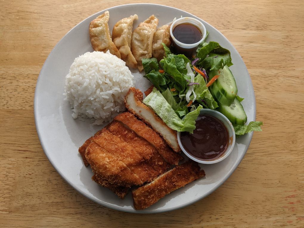 The chicken katsu bento box from Sushi Joa comes with four gyoza, rice, salad and a cup of miso soup. (Jackie Varriano / The Seattle Times)