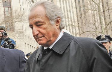 Bernard Madoff, right, arrives at Manhattan federal court in 2009. Hundreds of Ponzi schemes have been detected in the decade since Madoff admitted his. NY116