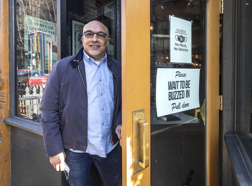 Ali Ghambari, owner of Cherry Street Coffee House, just installed new security at his Pioneer Square location to deal with street crime. Reliant on office workers and tourists, only four of his 11 downtown shops are open. (Steve Ringman / The Seattle Times)