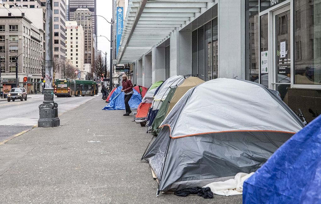 Tents line Third Avenue near Stewart Street in the heart of downtown Seattle. Until the local governments confront downtown’s homelessness, drug abuse and street crime, “talk of recovery is hollow,” says Jon Scholes, president of the Downtown Seattle Association. (Steve Ringman / The Seattle Times)