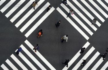 FILE – In this Friday, Jan. 8, 2021 file photo, people wearing protective masks to help curb the spread of the coronavirus walk along pedestrian crossings in the Ginza shipping area of Tokyo. Health officials around the world are racing to vaccinate enough people to stop the spread of COVID-19 — but what qualifies as enough is still an open question. (AP Photo/Eugene Hoshiko)
