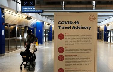 COVID-19 information is displayed at an international terminal at John F. Kennedy Airport (JFK) on January 25, 2021, in New York City. (Spencer Platt/Getty Images/TNS) 9302220W 9302220W