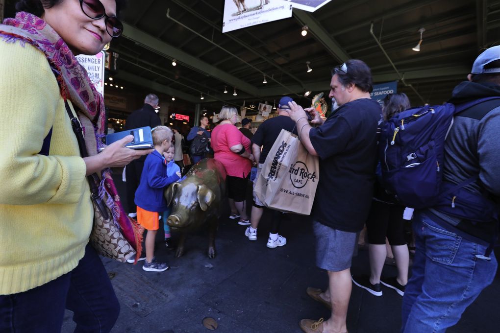Rachel the Pig, mascot of Pike Place Market, is at a busy crossroad in the market just below the clock in 2018. Will we ever feel comfortable return to crowded public spaces after the pandemic? (Alan Berner / The Seattle Times)