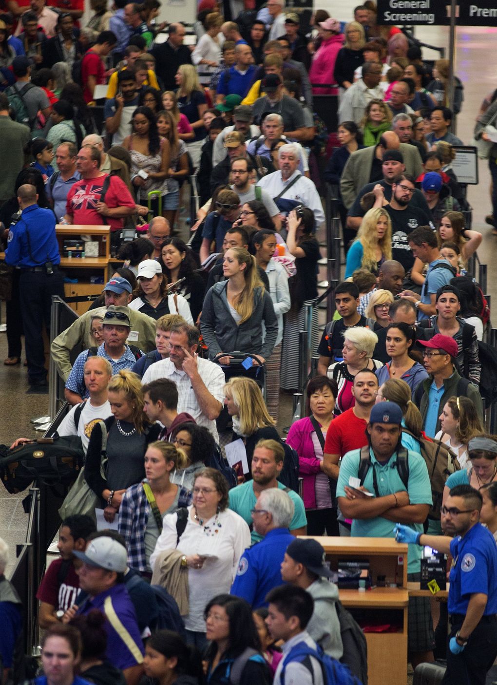 Crowded airports, such as this scene of a routine day at Seattle-Tacoma Airport in 2015, have become a thing of the past in the COVID-19 pandemic era. But some predict that people will be eager to travel again as we move through the pandemic and more people get vaccinated. (MIke Siegel / The Seattle Times)