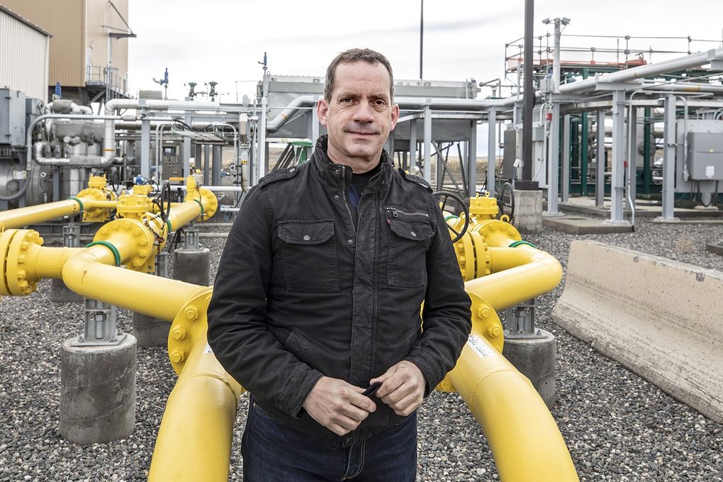 Kevin Ricks, renewable energy assets manager at the Klickitat Public Utility District, worked to develop the pipeline-quality renewable natural gas at the landfill. Operations started up in 2018. Here, he stands at the outbound pipe that carries away the gas to California markets as well as to the Puget Sound Energy gas network in Washington. (Steve Ringman / The Seattle Times)