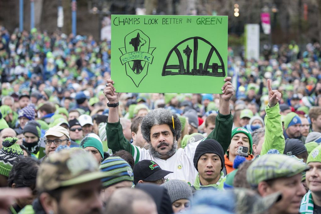 Kris ‘The Sonics Guy’ Brannon holds a sign that reads “Champs look better in green” at the Sounders FC MLS Cup victory rally at the Seattle Center Tuesday December 13, 2016. (Bettina Hansen / The Seattle Times)