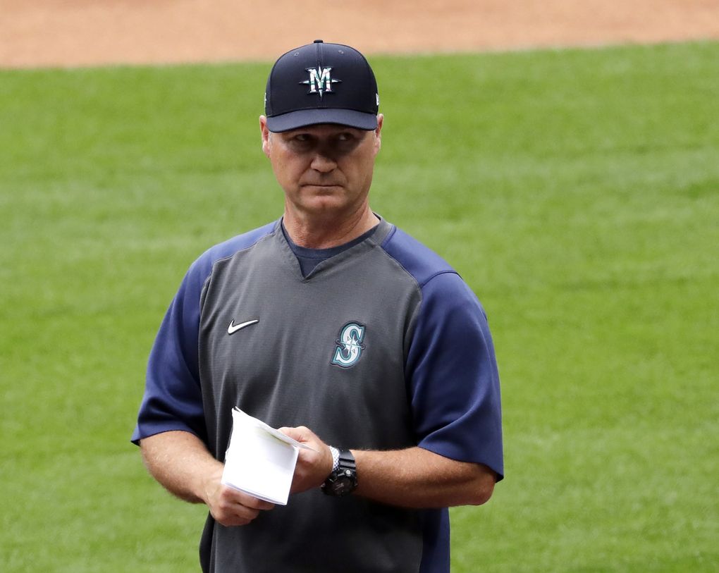 In this July 3, 2020, file photo, Seattle Mariners manager Scott Servais walks on the field at a “summer camp” baseball workout on their ballpark field in Seattle. (Elaine Thompson / The Associated Press)
