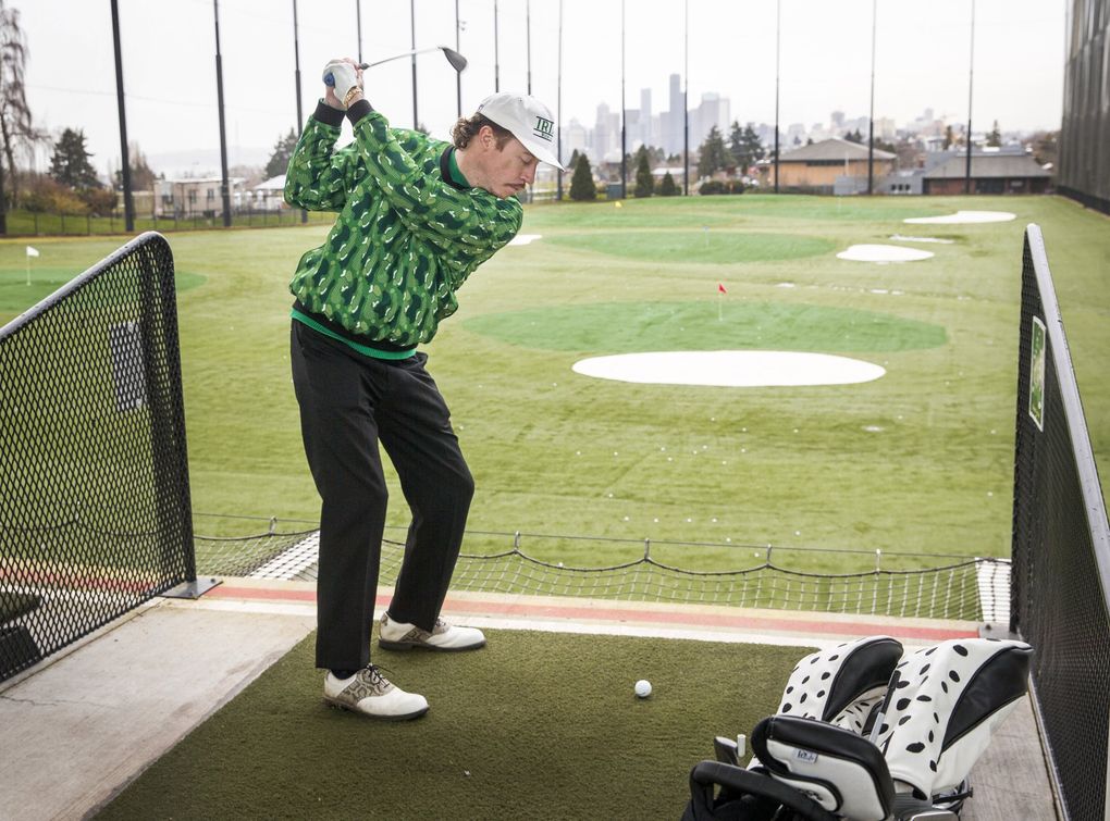 Seattle rapper Macklemore, who’s become obsessed with golf lately, hits a golf ball at Jefferson Park driving range on Feb. 18. (Amanda Snyder / The Seattle Times)