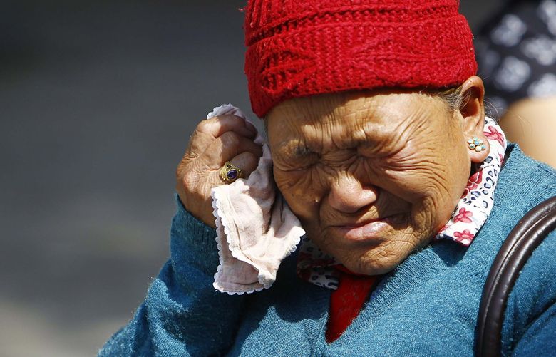 Mother of Nepalese mountaineer Ang Kaji Sherpa, killed in an avalanche on Mount Everest, cries while she waits for his body at Sherpa Monastery in Katmandu, Nepal, Saturday, April 19, 2014. Rescuers were searching through piles of snow and ice on the slopes of Mount Everest on Saturday for four Sherpa guides who were buried by an avalanche that killed 12 other Nepalese guides in the deadliest disaster on the world’s highest peak. The Sherpa people are one of the main ethnic groups in Nepal’s alpine region, and many make their living as climbing guides on Everest and other Himalayan peaks. (AP Photo/Niranjan Shrestha) DEL101