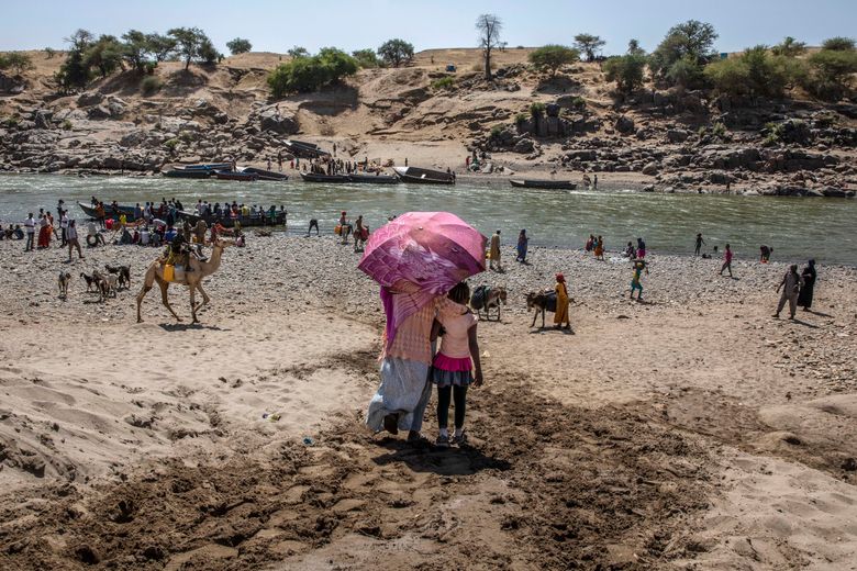 FILE – In this Nov. 21, 2020, file photo, refugees who fled the conflict in Ethiopia’s Tigray region arrive on the banks of the Tekeze River on the Sudan-Ethiopia border, in Hamdayet, eastern Sudan. Huge unknowns persist in the deadly conflict, but details of the involvement of neighboring Eritrea, one of the world’s most secretive countries, are emerging with witness accounts by survivors and others. (AP Photo/Nariman El-Mofty, File) CODZ504 CODZ504