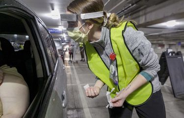 Nurse Madison Freenling prepares to administer a Moderna COVID-19 vaccine at a drive-thru vaccination clinic in Portland, Ore. (Kristyna Wentz-Graff/Pool Photo via AP, File)