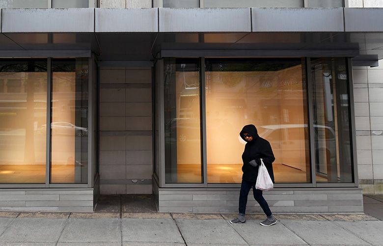 A pedestrian walks by empty window displays at a Neiman Marcus location in Washington, D.C. Big-name retailers have made headlines with bankruptcy filings, but other industries are seeing large increases as well. MUST CREDIT: Washington Post photo by Matt McClain