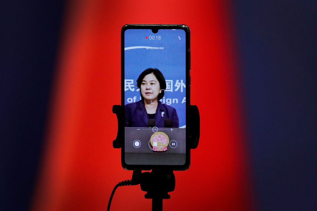 FILE – In this Sept. 1, 2020 file photo, a smartphone records Chinese Foreign Ministry spokeswoman Hua Chunying as she speaks during a daily briefing at the Ministry of Foreign Affairs in Beijing. “I’d like to stress that if the United States truly respects facts, it should open the biological lab at Fort Detrick, give more transparency to issues like its 200-plus overseas bio-labs, invite WHO experts to conduct origin-tracing in the United States,” she said at a January 2021 MOFA press conference that went viral in China. (AP Photo/Andy Wong)