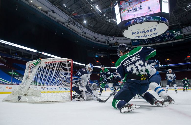 Laurent Brossoit makes 29 saves, Jets beat Canucks 2-0 - WTOP News