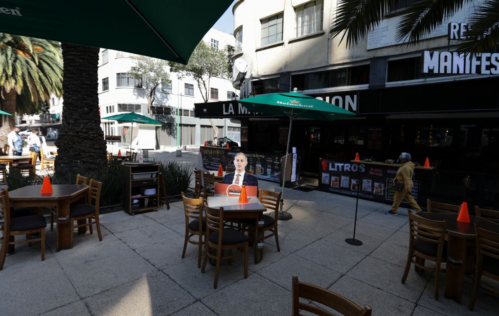 A life-size cutout of Deputy Health Secretary Hugo Lopez-Gatell is displayed on the patio of an outdoor restaurant in Mexico City, Thursday, Feb. 4, 2021. The city government has eased restrictions amid the COVID-19 “red alert” shutdown, allowing eateries to serve diners in socially distanced, preferably outdoor spaces. (AP Photo/Eduardo Verdugo)