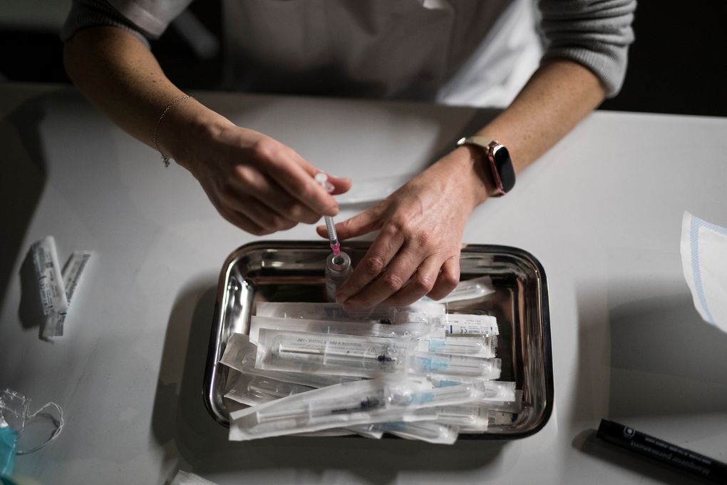 In this Thursday Jan. 21, 2021 file photo, Nurse Coralie Ferron prepares doses of the Moderna COVID-19 vaccine at a vaccination center in Le Cannet, southern France. France’s highest health authority, the High Authority of Health, or HAS, recommended Friday Feb. 12, 2021, that people who have had COVID-19 receive only one dose of a vaccine against the coronavirus. Since recovered individuals had developed an immunity response akin to a vaccine, a single shot is probably sufficient. (AP Photo/Daniel Cole, File)