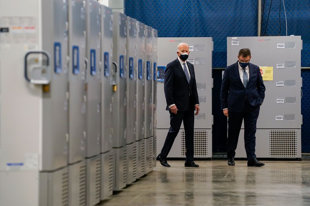 FILE – In this Feb. 19, 2021, file photo President Joe Biden walks by freezers used to hold the Pfizer COVID-19 vaccine as he tours a Pfizer manufacturing site with Albert Bourla, Pfizer CEO, in Portage, Mich. (AP Photo/Evan Vucci, File)