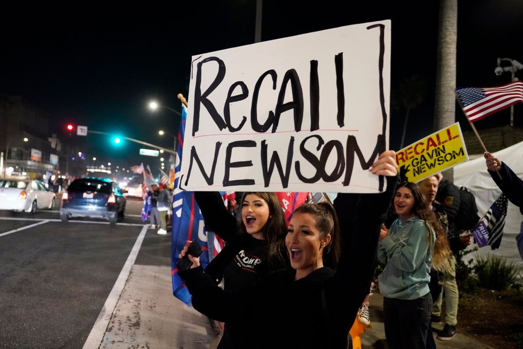 Demonstrators shout Nov. 21 while carrying a sign calling for the recall of Gov. Gavin Newsom during a protest against a stay-at-home order amid the COVID-19 pandemic in Huntington Beach. About a year after the state’s first coronavirus case, Newsom has gone from a governor widely hailed for his swift response to a leader facing criticism from all angles. (AP Photo/Marcio Jose Sanchez, file)