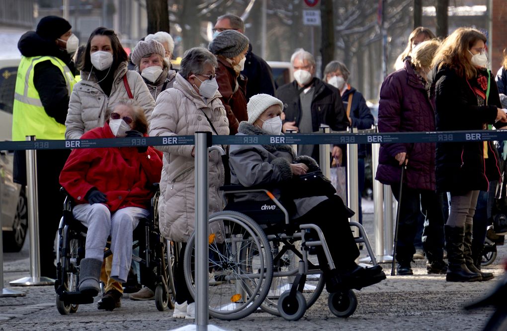 People queue in front of the vaccination center against the COVID -19 disease at the ‘Arena Treptow’ in Berlin, Germany, Monday, Feb. 1, 2021. Chancellor Angela Merkel and German state governors are going to talk on Monday with representatives of the pharmaceutical industry beefing up the country’s sluggish vaccination campaign. (AP Photo/Michael Sohn)