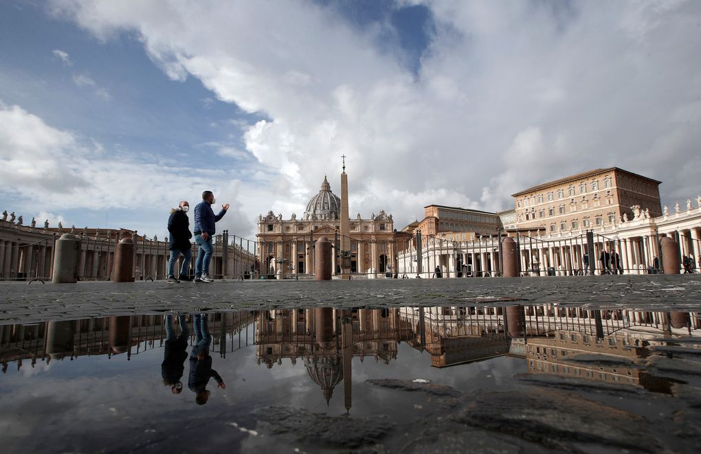 FILE – In this Sunday, Jan. 31, 2021 file photo, people are reflected on a puddle as they walk in St. Peter’s Square, at the Vatican. The Vatican is taking Pope Francis’ pro-vaccine stance very seriously: Any Vatican employee who refuses to get a coronavirus shot without valid medical reason risks being fired.
A Feb. 8 decree signed by the governor of the Vatican City State sparked heated debate Thursday, Feb. 18, 2021 since its provisions go well beyond the generally voluntary nature of COVID-19 vaccinations in Italy and much of the rest of the world. (AP Photo/Alessandra Tarantino, File)