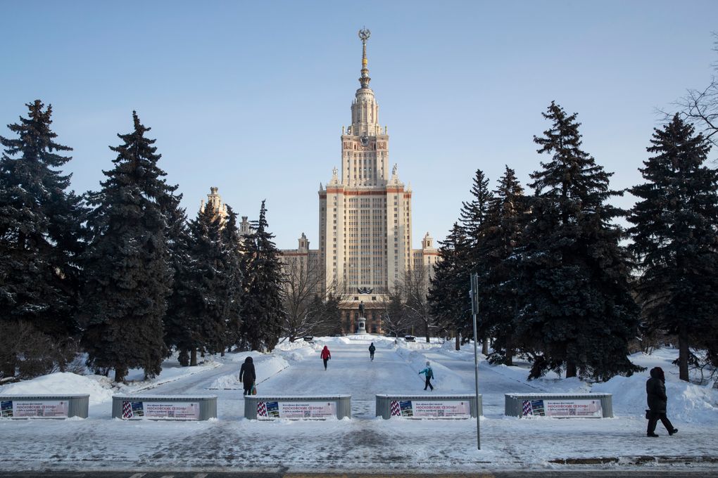 People walk towards the main building of the Moscow State University in Moscow, Russia, Monday, Feb. 8, 2021. Students of Moscow’s Universities returned to continued their studies on site. (AP Photo/Pavel Golovkin)