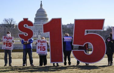 Activists appeal for a $15 minimum wage near the Capitol in Washington, Thursday, Feb. 25, 2021. The $1.9 trillion COVID-19 relief bill being prepped in Congress includes a provision that over five years would hike the federal minimum wage to $15 an hour. (AP Photo/J. Scott Applewhite) DCSA102 DCSA102