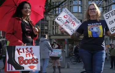 Sex workers carry signs protesting unequal treatment and stigmatizing during a demonstration in The Hague, Netherlands, Tuesday, March 2, 2021. Stores in one village opened briefly, cafe owners across the Netherlands were putting tables and chairs on their outdoor terraces and sex workers demonstrated outside parliament in protests against the government’s tough coronavirus lockdown. (AP Photo/Patrick Post) PDJ129 PDJ129