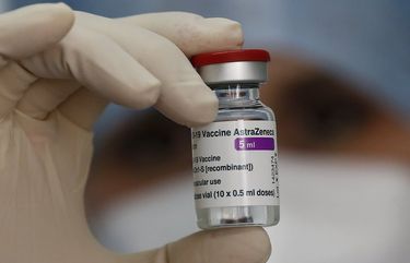 A health worker holds up a dose of the AstraZeneca vaccine against COVID-19 to be administered to members of the Italian Army at a vaccination center set up at the military barracks of Cecchignola, in Rome, Tuesday, Feb. 23, 2020.  (Cecilia Fabiano/LaPresse via AP) ROM805