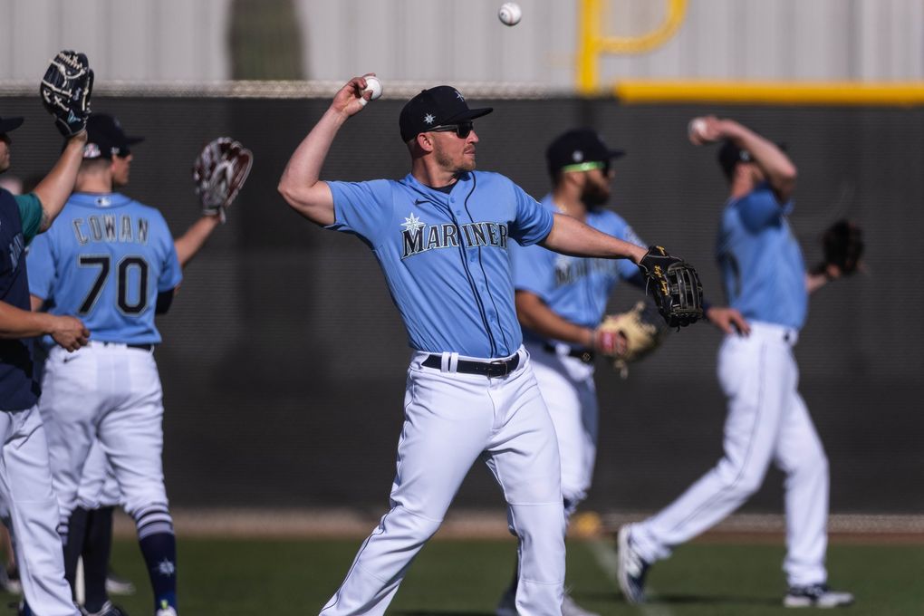 Kyle Seager and Mariners infielders warm up for practice late last month at Peoria Sports Complex in Arizona. (Dean Rutz / The Seattle Times)