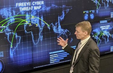 The CEO of FireEye Kevin Mandia gives a tour of the cybersecurity company’s unused office space in Reston, Va., Tuesday, March 9, 2021. Mandia said 550 of his employees are working remotely and responding to a recent barrage of cyber breaches, including four different zero-day attacks against Microsoft Exchange. (AP Photo/Nathan Ellgren) VANE101 VANE101