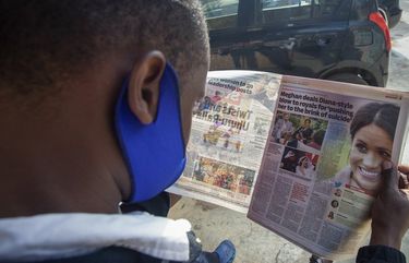 A man reads a copy of The Standard newspaper with coverage of the two-hour appearance of Britain’s Prince Harry and Meghan with Oprah Winfrey, in Nairobi, Kenya Tuesday, March 9, 2021. Prince Harry and Meghan’s explosive TV interview divided people around the world on Monday, rocking an institution that is struggling to modernize with claims of racism and callousness toward a woman struggling with suicidal thoughts. (AP Photo/Sayyid Abdul Azim) NAI101 NAI101