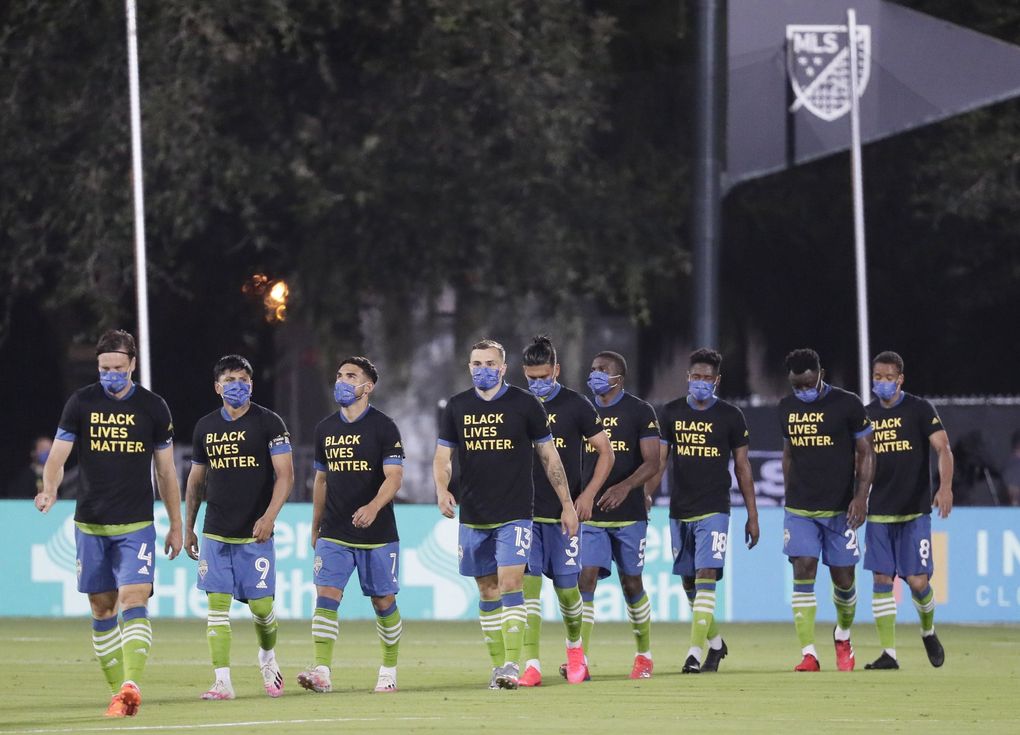 Seattle Sounders players, wearing masks to prevent the spread of the new coronavirus, take the field before the start of an MLS soccer match against the San Jose Earthquakes, Friday, July 10, 2020, in Kissimmee, Fla. (John Raoux / AP)