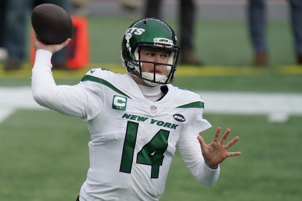 New York Jets quarterback Sam Darnold rolls out to pass against the New England Patriots in the first half of a game in January in Foxborough, Mass. (Charles Krupa / AP)